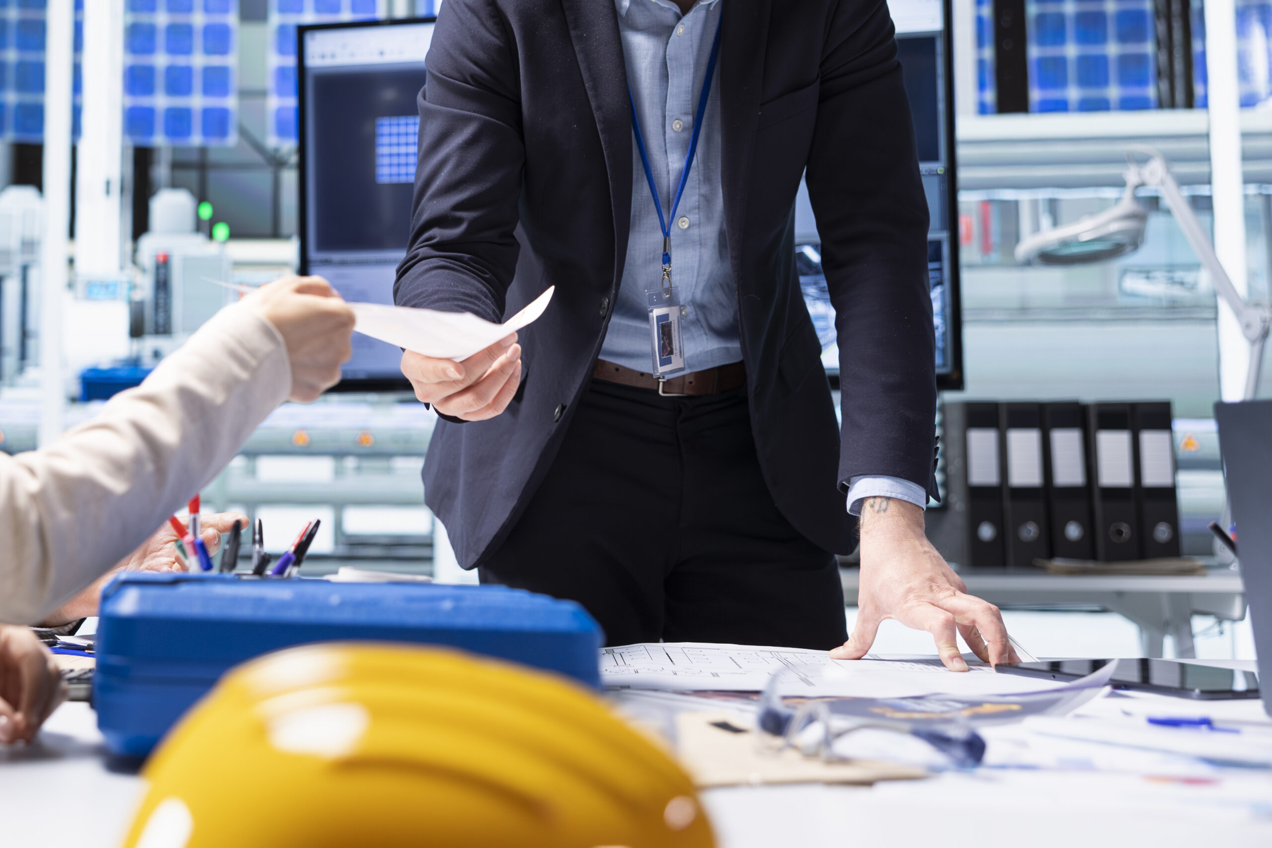 Shareholders reading report of industrial production growth opportunities and technological insights found during research and development process. Factory manager offers investors documentation files